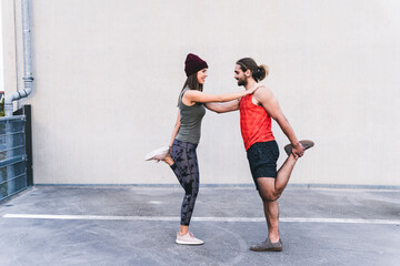 Fit young couple doing partner exercises