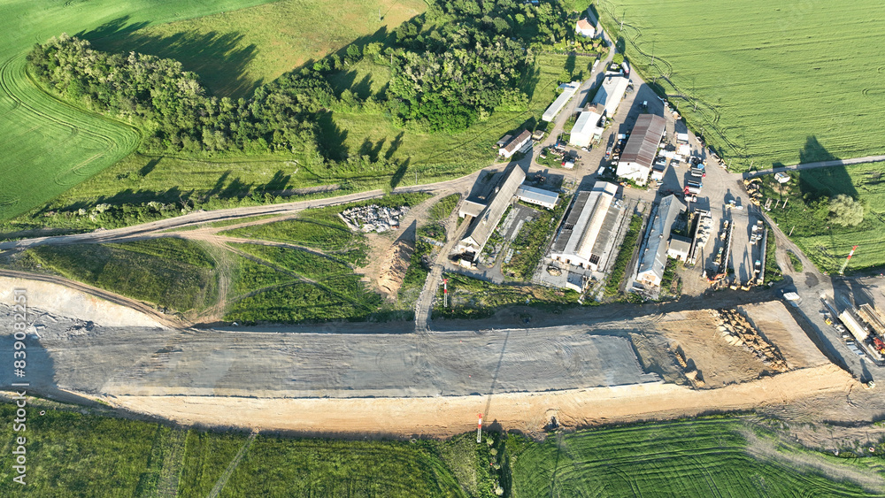 Wall mural Highway destruction village in construction drone aerial Czech Prerov, agricultural land fields, remove of people houses and buildings land grabbing extension works additional lanes way new road