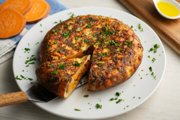 Spanish omelette with sweet potato, onion and egg. Traditional tapa of Spanish gastronomy.