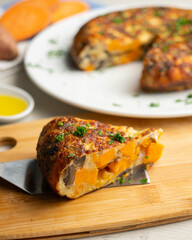 Spanish omelette with sweet potato, onion and egg. Traditional tapa of Spanish gastronomy.