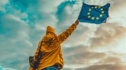 Patriotic European Citizen Waving the EU Flag Under Cloudy Sky