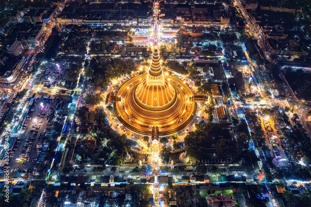 Sticker Majestic golden pagoda of Phra Pathom Chedi glowing among the festival lights around the roundabout road in downtown at Nakhon Pathom