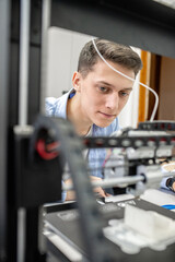 Student setting up 3D printer, close up