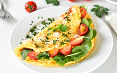 Stuffed omelette with tomatoes and spinach