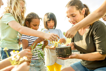 Techer showing children, how to make a herbal infusion