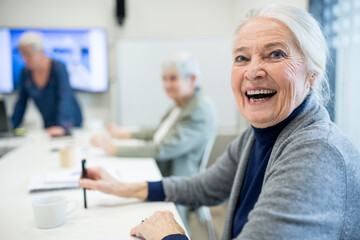 Happy senior woman attending seniors education course