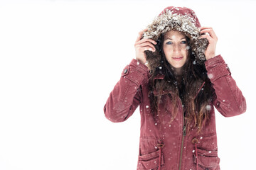Portrait of young woman wearing hooded jacket in winter