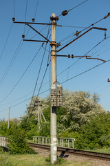 Obraz premium A pole with power wires near the railway track