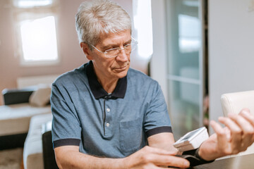 Senior man taking his blood pressure