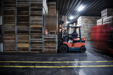 Man on forklift in factory hall
