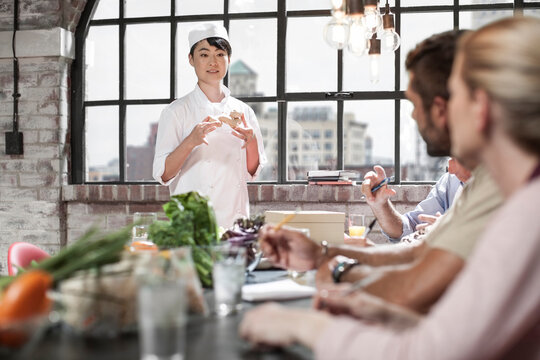 Female chef talking to students in cooking class
