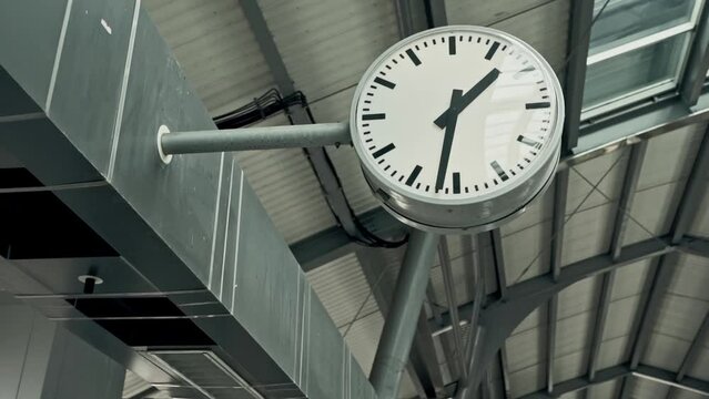 round clock at a train station showing the time 