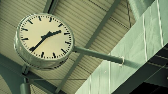 round clock at a train station showing the time 