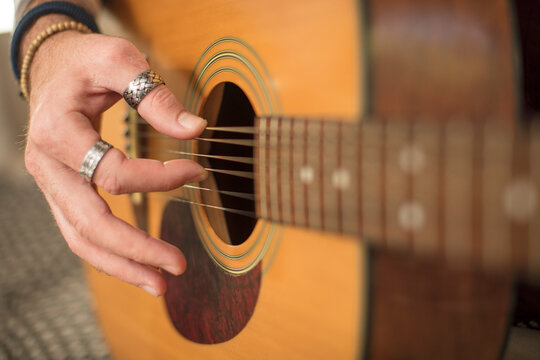 Close-up of man's hand playing guitar