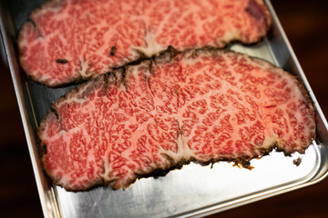 Dry-aged beef sliced with marbled texture. High quality Japanese Wagyu beef. Food ingredient concept.