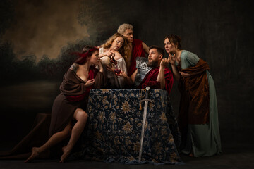 Obraz premium In this evocative family tableau, central armored man flanked by family members who appear to be both advising and comforting him. Emotional strength found within family bonds. Psychology concept.