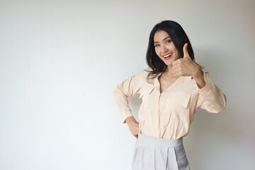 Fototapeta premium Asian Woman giving approving thumb up for yes, alright, ok, positive, OK for all correct gesture