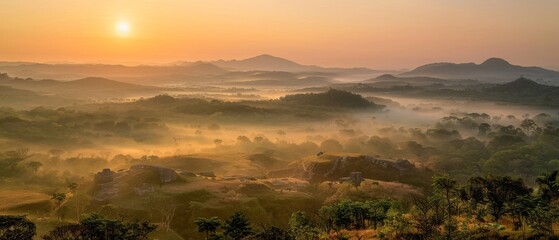 Obraz premium Golden Sunrise Over Misty Hills