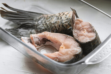 fresh raw fish in glass container, close-up