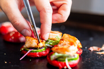chef hand cooking set mini hamburgers, mini burgers on restaurant kitchen