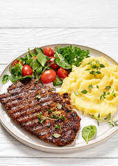grilled pork steak with mashed potato and salad