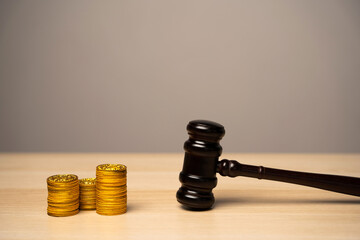 Judge's gavel and stack of coins. Litigation, dispute resolution, conflict of interest settlement....