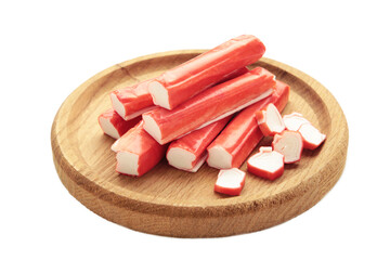 Crab sticks on cutting board isolated on white background.