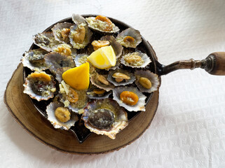 Azores cuisine -Lapas, a mollusk similar to clams, also known as limpets,prepared in a griddle pan, cooked simply in a sauce of butter, garlic, and lemon juice