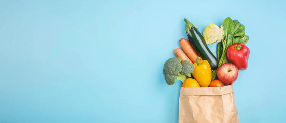 Groceries including fresh produce artfully overflowing from a paper bag on a blue background.