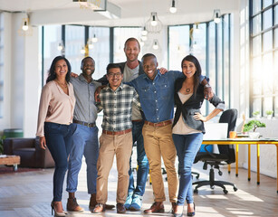 Obraz premium Business people, hug and team in office with portrait for creative collaboration, project development and professional staff. Happiness, group and partnership with diversity and designer workforce.