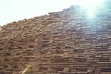 Stacked Lumber Boards at a Lumber Yard on a Sunny Day