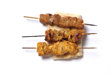 close-up view of delicious kebabs on skewers on white background
