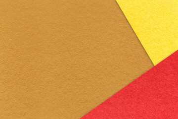 Fototapeta premium Texture of craft ocher color paper background with yellow and red border. Vintage abstract brown cardboard.