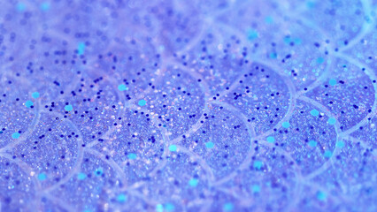 Glitter gloss spill. Sparkling paint texture. Blur purple blue color shimmering sequin particles in translucent gel serum fluid wave abstract art background with bokeh lights.