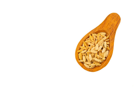 Raw Italian risoni pasta made from wheat - Raw orzo pasta on spoon
