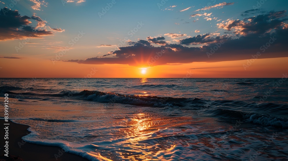 Poster a sunset over the ocean with waves coming in to shore