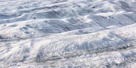 Obraz premium Glacial field in the mountains, close-up on rough ice surface and snow, cold, crisp morning light. 