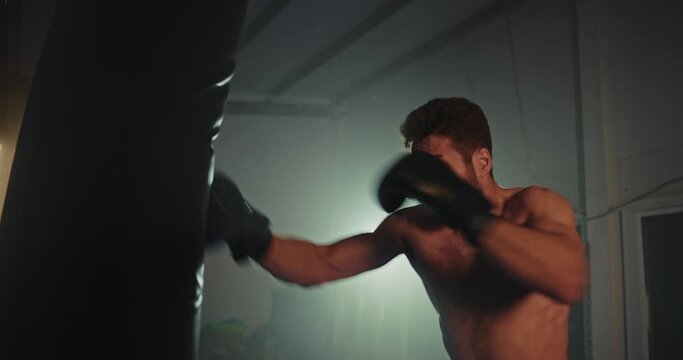 Shirtless Man Squatting in Boxing Ring