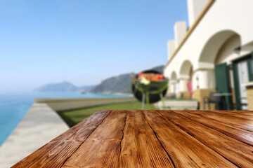 Wooden desk of free space and grill party in garden 