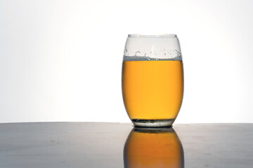Close-up of a Beer in clear glass against a white background.