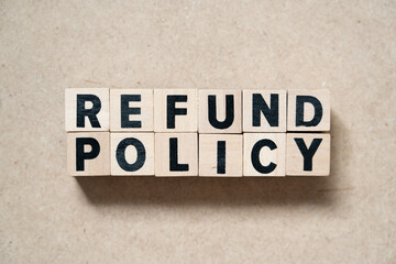 Alphabet letter block in word refund policy on wood background