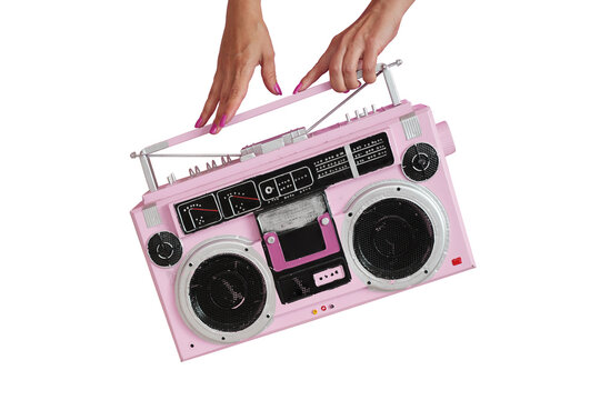 Woman hands holding retro outdated portable stereo boombox radio receiver. Vintage old 80's style photo.