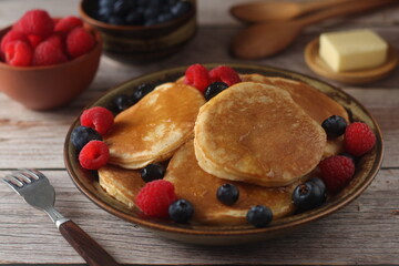 Pancakes with berries in rustic style