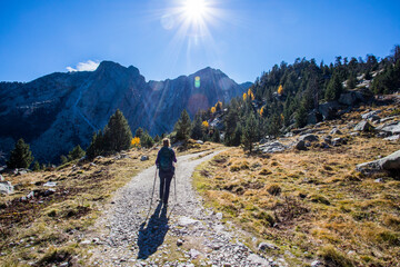 Young hiker woman in autumn in Aiguestortes and Sant Maurici National Park, Spain