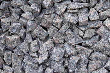 Fototapeta premium granite stones. large number of small gray granite stones top view close up concept of stones