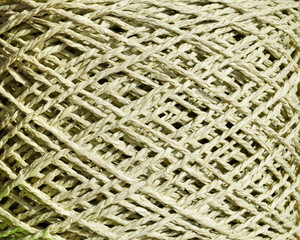 An olive skein of raffia is ready for knitting. Eco-friendly handmade material.