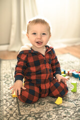 Fototapeta premium baby toddler playing color cubes toys at home or nursery