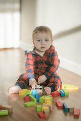 baby toddler playing color cubes toys at home or nursery