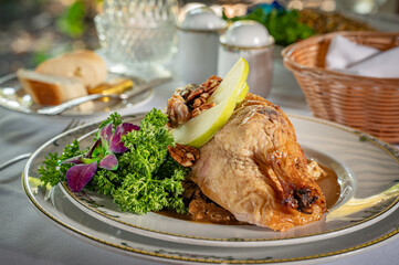 Roasted duck, partially boned, filled with bread stuffing and served with tangy sweet seasonal fruit sauce.