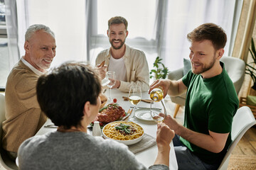 A gay couple enjoys a meal with parents at home.